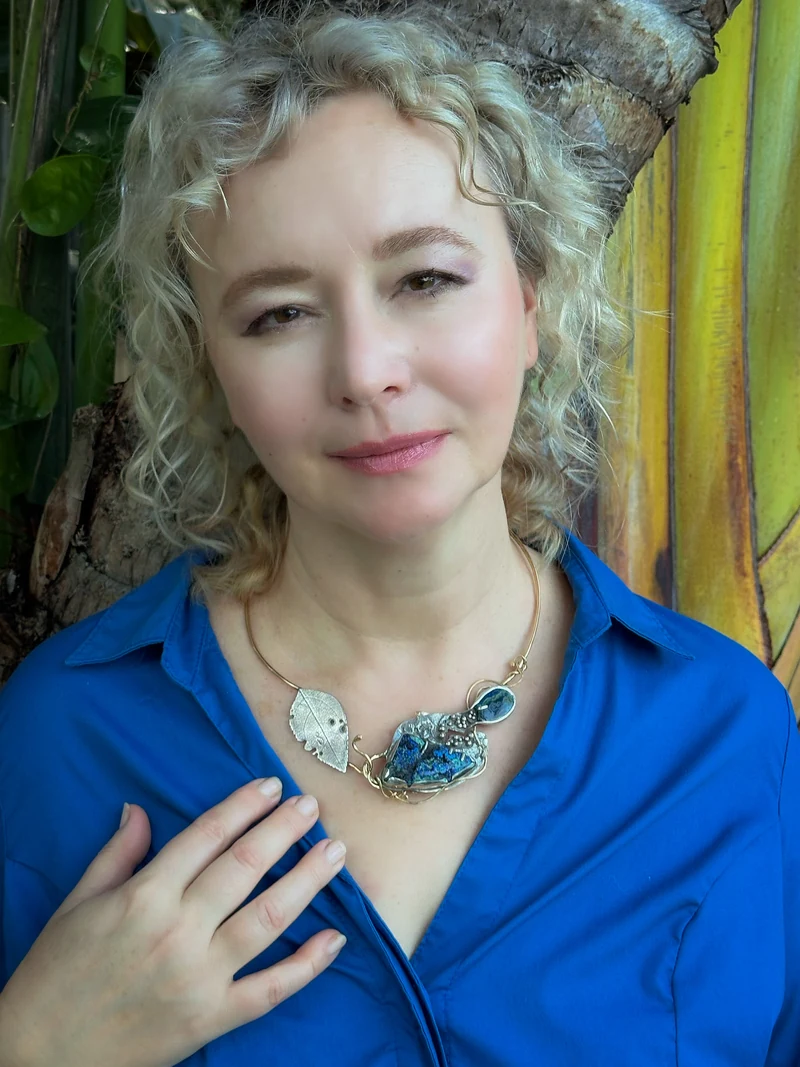 Jewelry artist Natalya Frolova wearing Beyond beside a palm tree in South Florida.